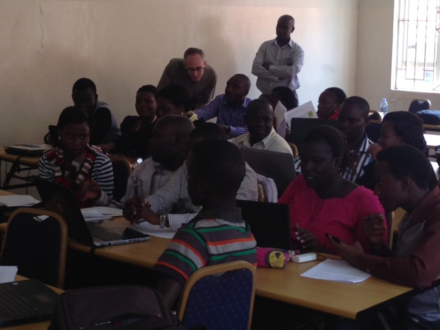 Participant at Makerere University Training explains an issue to Matt Sobek while Professor Edward Kaweesi looks on (Photo by Ann Meier).]