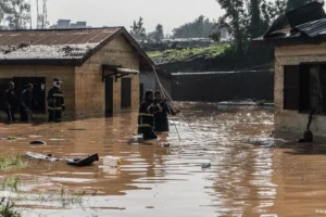 Men wading through flood waters